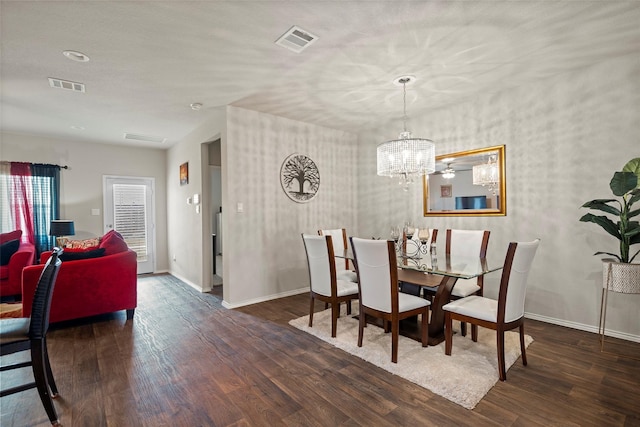 dining space featuring dark hardwood / wood-style floors and a notable chandelier