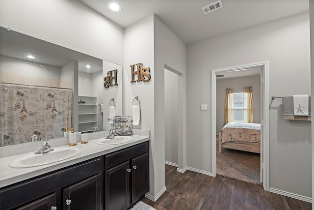 bathroom with walk in shower, hardwood / wood-style flooring, and vanity