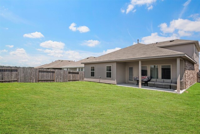 back of house with a lawn, outdoor lounge area, and a patio area