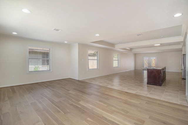 unfurnished living room with light hardwood / wood-style flooring and a healthy amount of sunlight