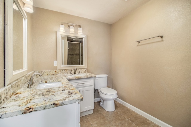 bathroom with tile patterned floors, an enclosed shower, vanity, and toilet