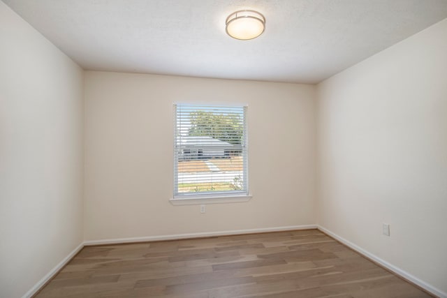 empty room featuring hardwood / wood-style flooring