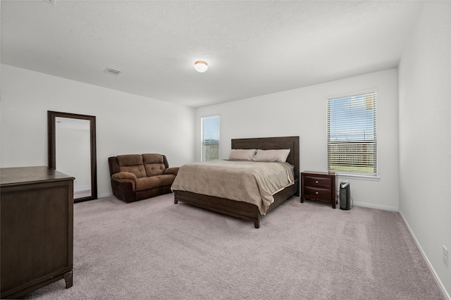 carpeted bedroom with a textured ceiling