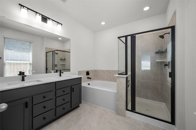 bathroom featuring independent shower and bath, tile patterned flooring, and vanity