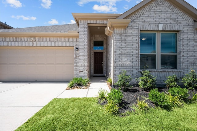 single story home featuring a garage, concrete driveway, and brick siding