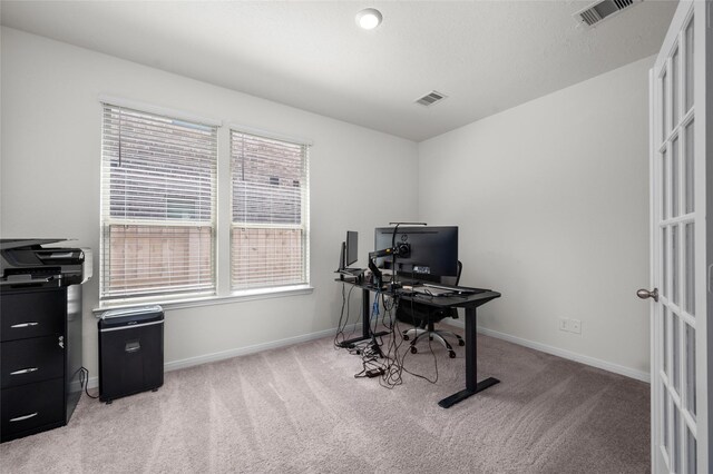 office space with visible vents, baseboards, and light colored carpet