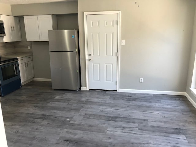 kitchen with hardwood / wood-style flooring, stainless steel appliances, and white cabinets