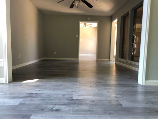 unfurnished room featuring ceiling fan and dark hardwood / wood-style floors