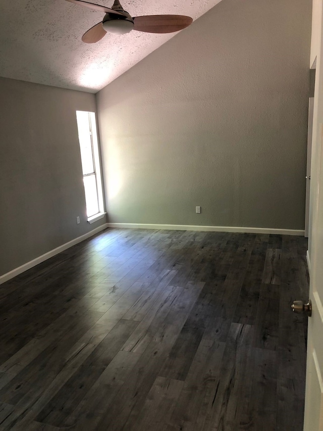 empty room with ceiling fan, a textured ceiling, and dark hardwood / wood-style flooring