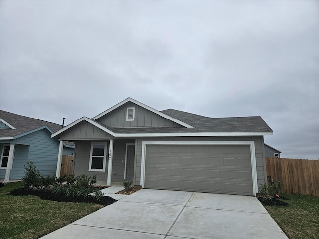 view of front of property featuring a garage and a front yard