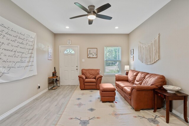 living room featuring ceiling fan and light hardwood / wood-style flooring