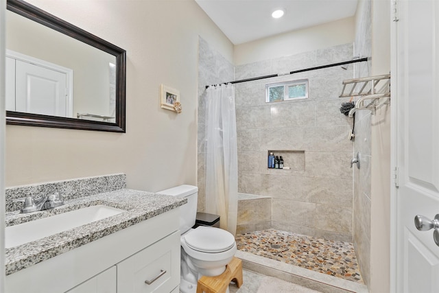 bathroom featuring walk in shower, vanity, and toilet