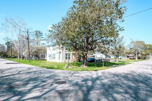 view of side of home with a yard