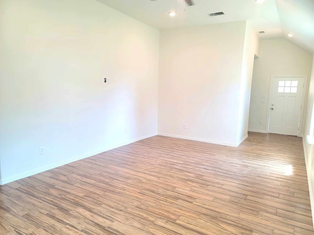 empty room with vaulted ceiling, light hardwood / wood-style floors, and ceiling fan