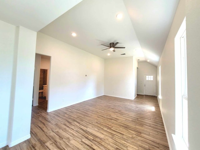 spare room with vaulted ceiling, light hardwood / wood-style floors, and ceiling fan