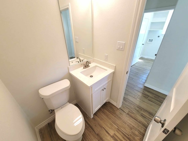 24644 Cavan St, Hempstead, TX 77445 - bathroom with toilet, vanity, wood finished floors, and baseboards