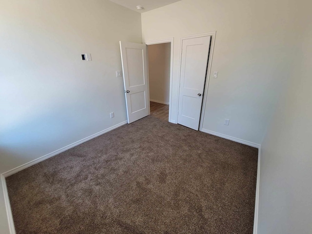 empty room with dark carpet