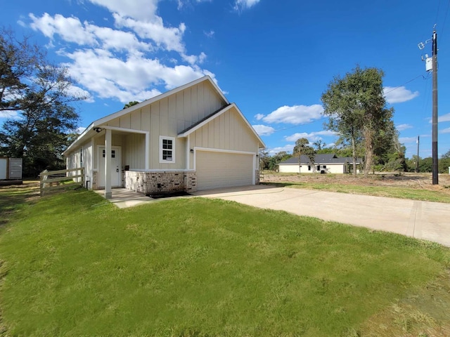 24644 Cavan St, Hempstead, TX 77445 - view of front facade with brick siding, driveway, a front lawn, board and batten siding, and a garage