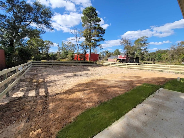 view of yard with a rural view