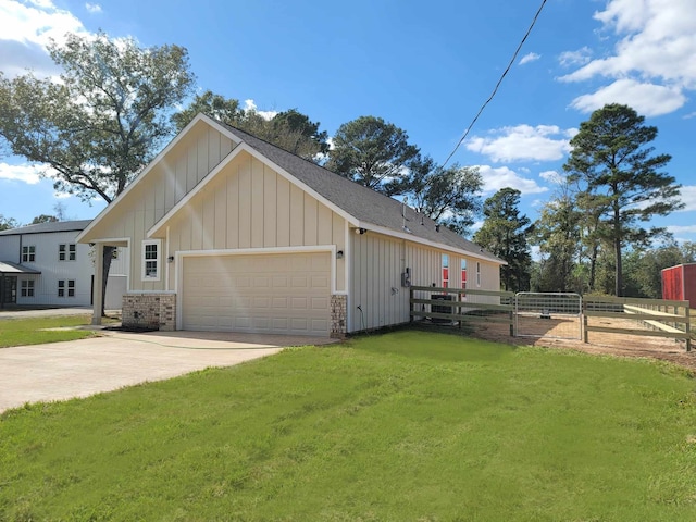 view of side of property with a yard and a garage