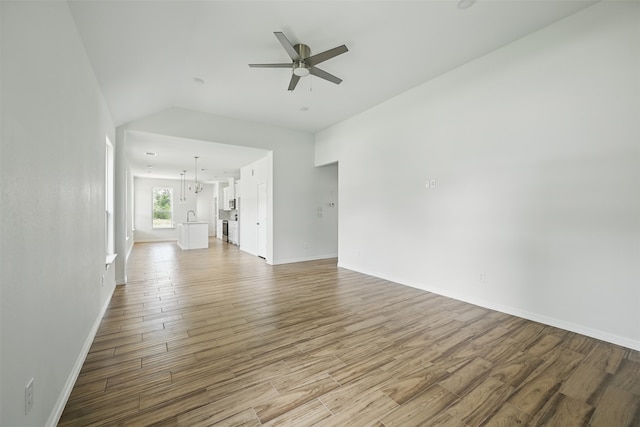 24644 Cavan St, Hempstead, TX 77445 - unfurnished living room with ceiling fan, wood finished floors, baseboards, and lofted ceiling
