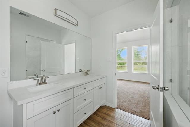 24644 Cavan St, Hempstead, TX 77445 - full bath featuring double vanity, baseboards, and wood finished floors