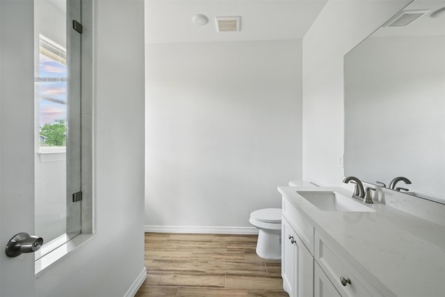 24644 Cavan St, Hempstead, TX 77445 - bathroom with baseboards, vanity, toilet, and wood finished floors
