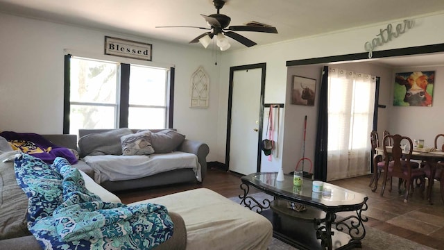 living room featuring ceiling fan and dark wood-type flooring