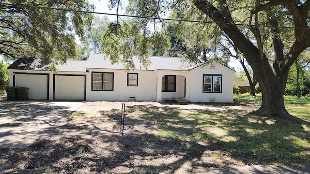 single story home featuring a garage and a front yard