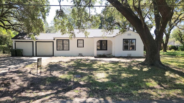 ranch-style home with a front yard and a garage