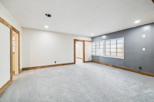 empty room featuring a textured ceiling and plenty of natural light