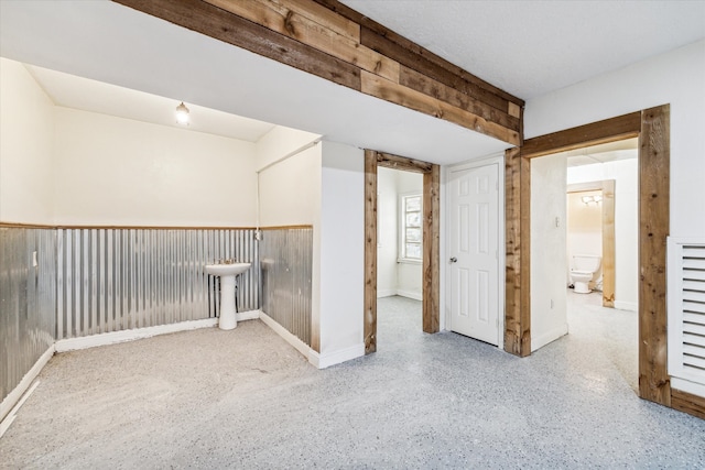 spare room featuring wooden walls