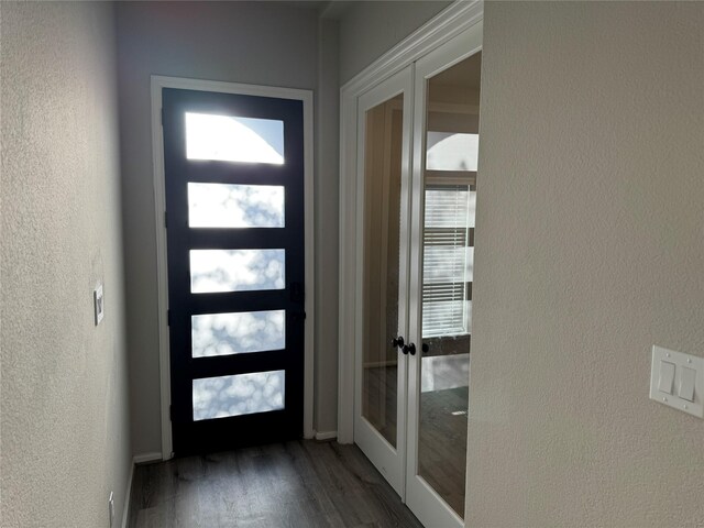 doorway to outside with dark wood-type flooring, french doors, and a wealth of natural light