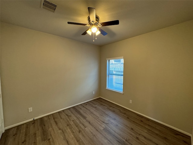 empty room with ceiling fan and hardwood / wood-style floors