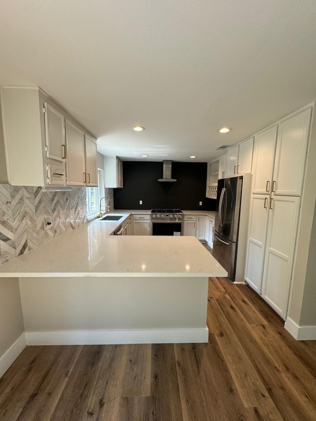 kitchen featuring sink, stainless steel appliances, dark hardwood / wood-style flooring, backsplash, and kitchen peninsula