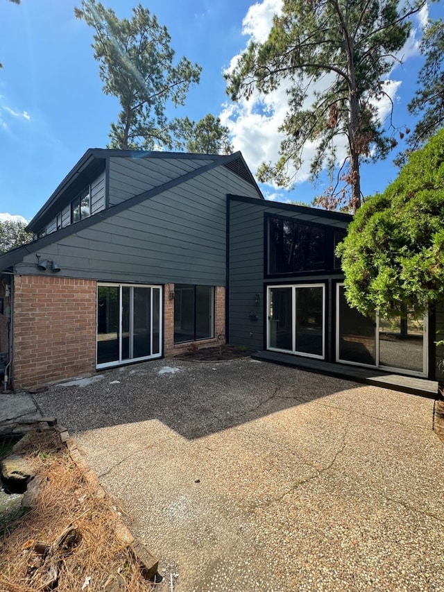 back of property with a patio