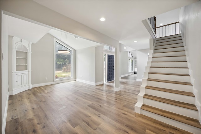 interior space with wood-type flooring and vaulted ceiling