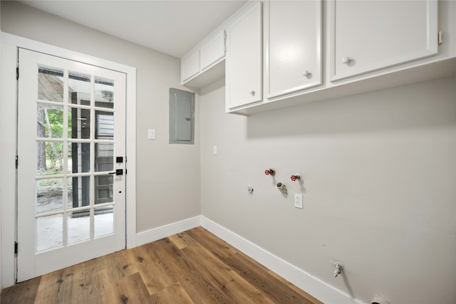 washroom featuring gas dryer hookup, cabinets, light wood-type flooring, and electric panel