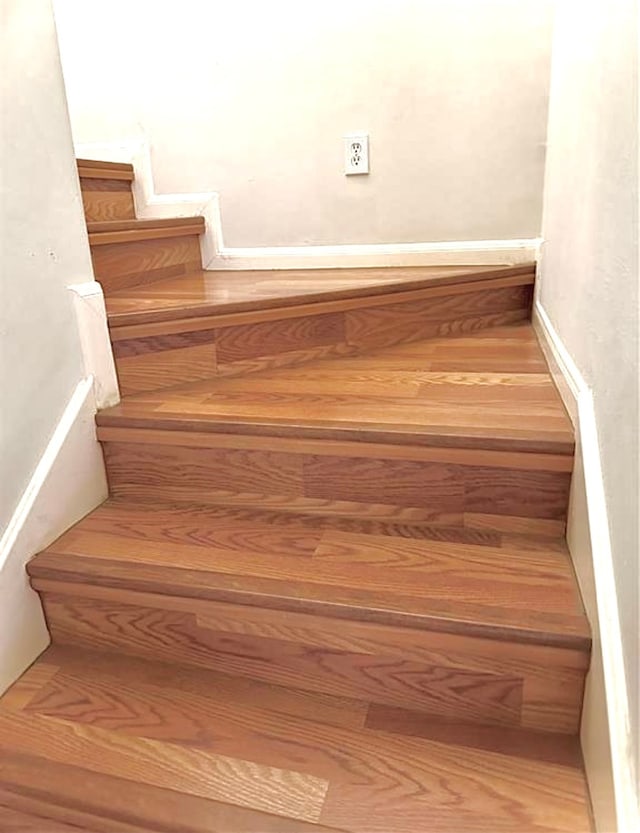 stairs featuring hardwood / wood-style flooring