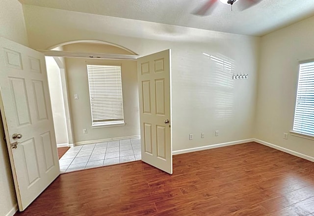 empty room featuring wood-type flooring and ceiling fan