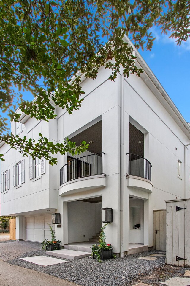 exterior space featuring a balcony and a garage