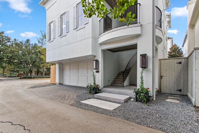 exterior space featuring a balcony and a garage