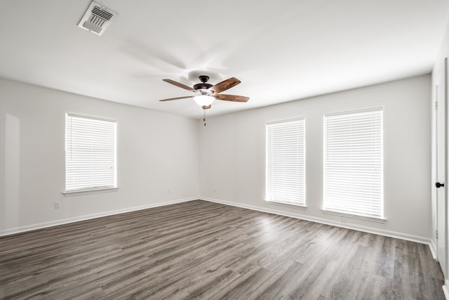 spare room with ceiling fan and dark wood-type flooring