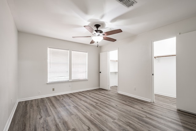 unfurnished room featuring ceiling fan and hardwood / wood-style flooring