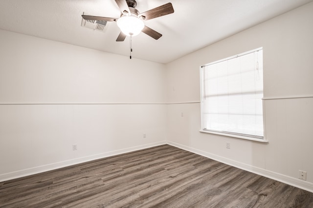 empty room with ceiling fan and dark hardwood / wood-style floors