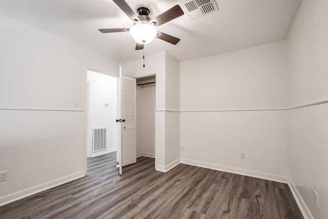 unfurnished bedroom featuring a textured ceiling, dark hardwood / wood-style floors, ceiling fan, and a closet