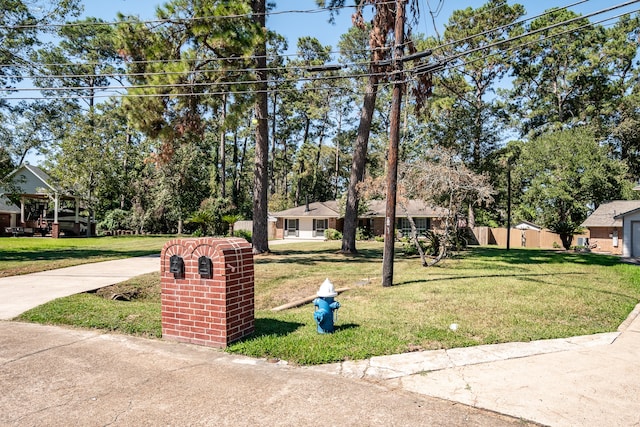 ranch-style home with a storage shed and a front lawn