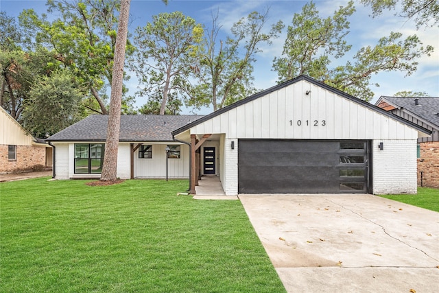 view of front of property with a garage and a front lawn