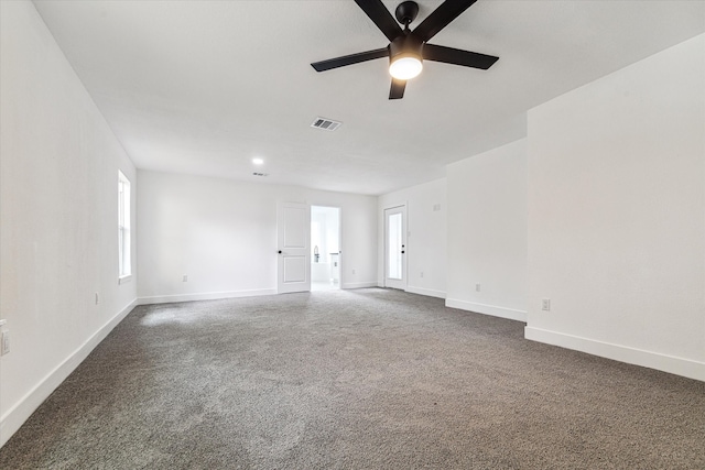 spare room featuring ceiling fan and carpet floors