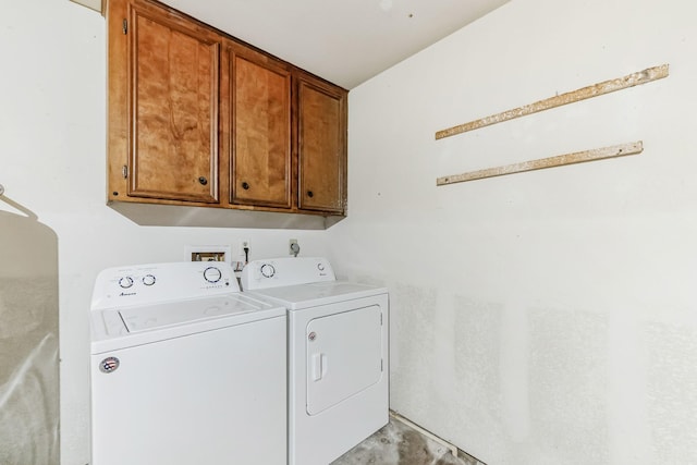 laundry area with cabinets and washing machine and clothes dryer